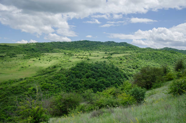 A landscape of green hills and a blue sky with clouds. High quality photo