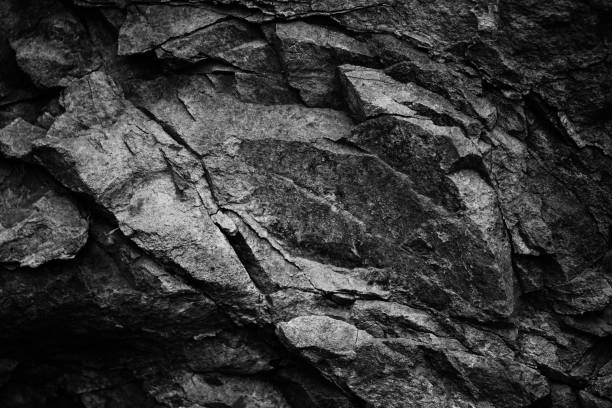 istock Black white dark gray stone rock granite background. Mountain surface texture. Close-up. For design. 2203279500
