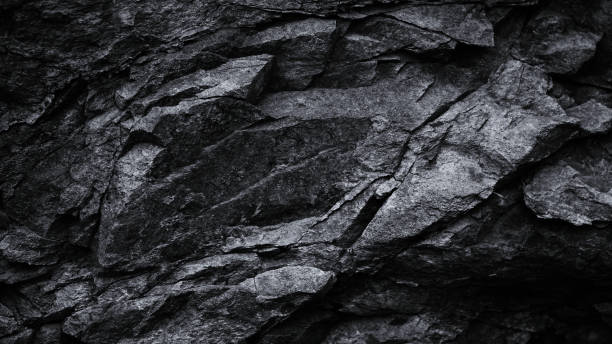 istock Black white dark gray stone rock granite background. Mountain surface texture. Close-up. For design. 2203279965