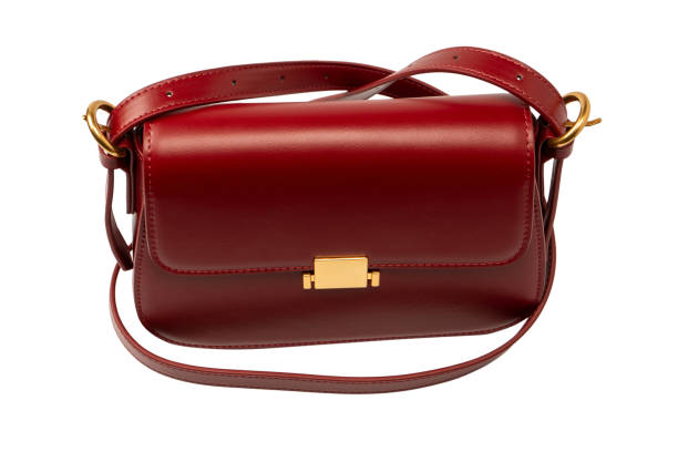 Burgundy shoulder leather bag isolated on a white background.