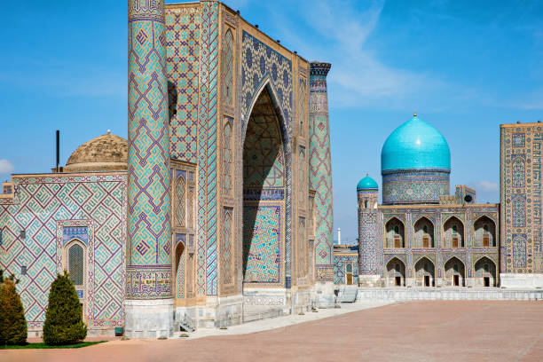 istock Registan Square in Samarkand, Uzbekistan, a historic architectural ensemble featuring three stunning madrasas with intricate mosaic designs, domes, and minarets under a bright blue sky 2203282325