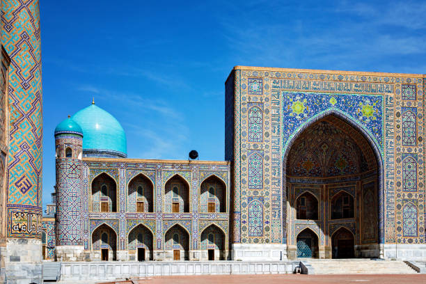 istock Registan Square in Samarkand, Uzbekistan, a historic architectural ensemble featuring three stunning madrasas with intricate mosaic designs, domes, and minarets under a bright blue sky 2203282347