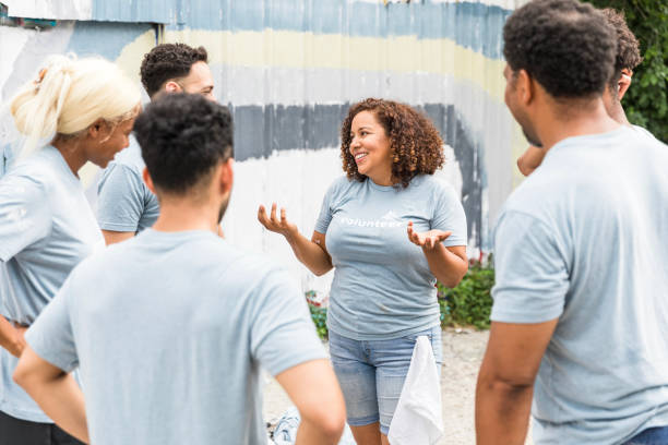 istock Teamwork and Community Outreach: Volunteers Engaging in Discussion 2203282603