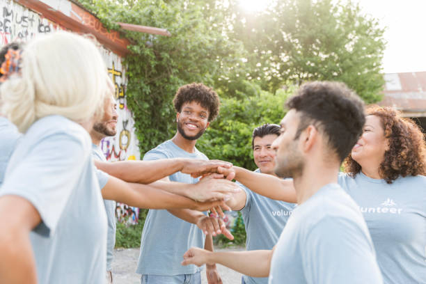 istock Multiracial Group of Volunteers Stacking Hands, Teamwork Concept 2203282635