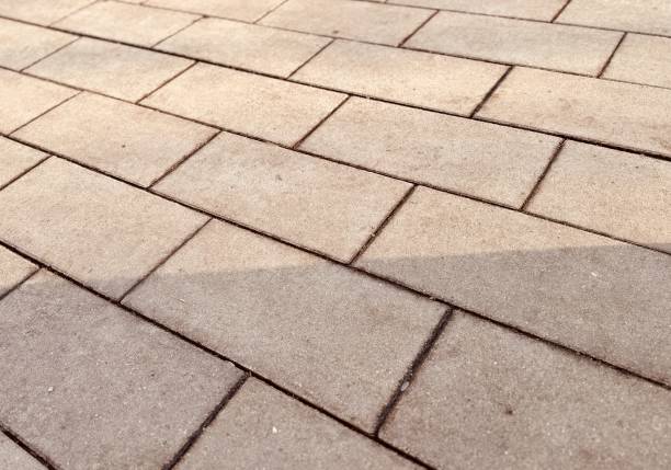 istock A closeup image of a textured, paved pathway prominently showcasing intricate block patterns and their shadows 2203284021