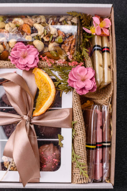 istock Gift box with a jar of nuts with honey, chocolate and craft candies 2203287921