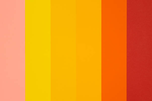 A minimalist photograph capturing an orange wall illuminated by a light source, creating a gradient effect from bright to dark. The shadow adds depth and contrast, evoking a serene and contemplative mood. Suitable for artistic projects focusing on color theory, lighting effects, or abstract design.