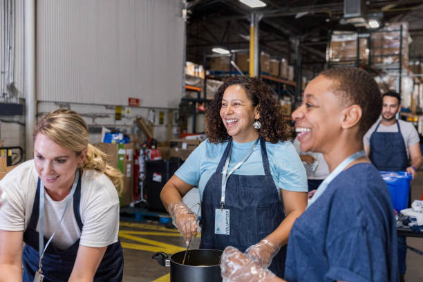 istock Volunteers Cooking Together in a Warehouse 2203291279