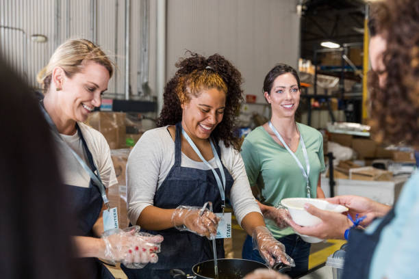 istock Happy volunteers preparing food at a soup kitchen 2203291304