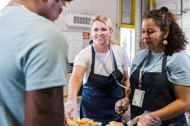 istock Volunteers Serving Food at Community Outreach Program 2203291324