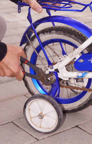 istock dad repairs kids bicycle 2203291919