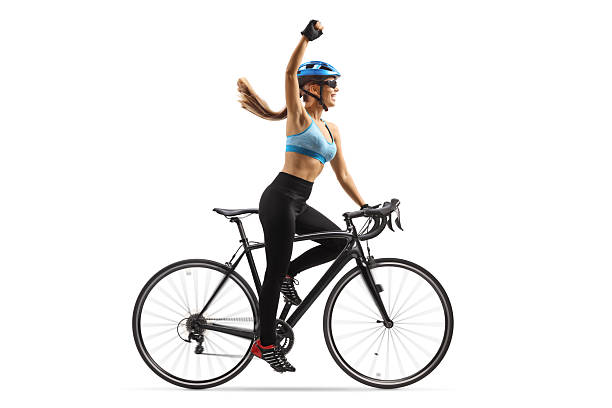 Athlete woman training on stationary bike in fitness gym.