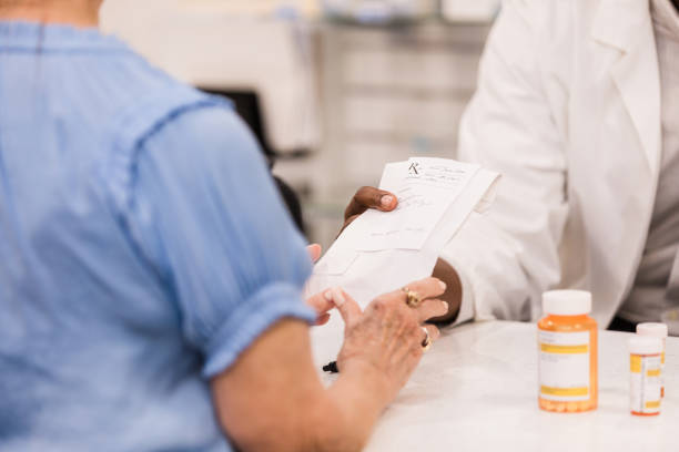 istock Pharmacist explaining prescription medication to patient 2203297574