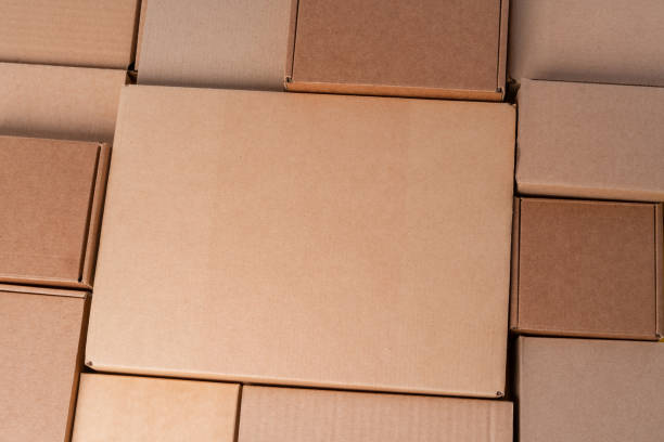 istock Cardboard boxes stacked in a pile as a background 2203298695