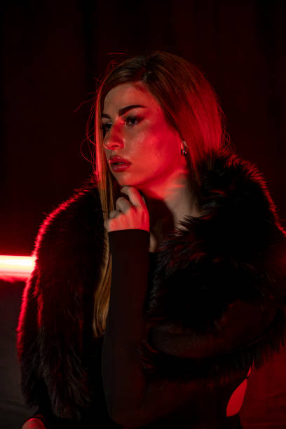 istock A lady poses in a black fur coat. 2203300330