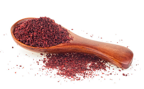 istock Ground sumac spice in wooden spoon isolated on a white background 2203302797