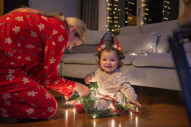 istock Holiday Cheer: Smiling Baby Amid Christmas Decorations 2203302994