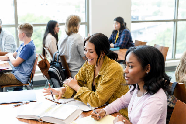 istock Two female college students studying together in a classroom 2203305680