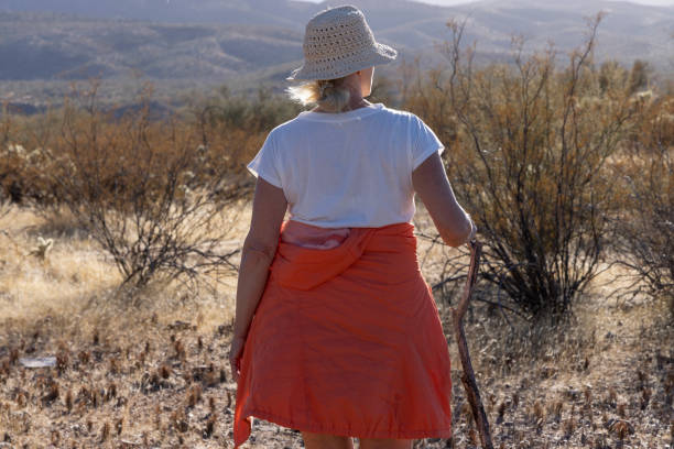Close up of mature woman hiking in desert landscape at sunset, Tonto Basin, AZ