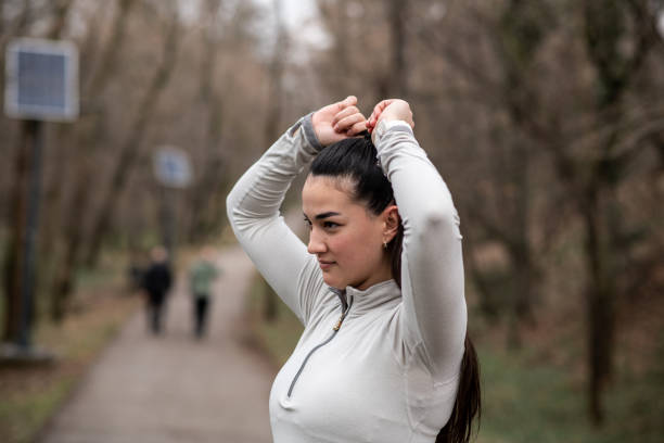 istock Getting Ready – Tying Her Hair for the Perfect Run 2203307335