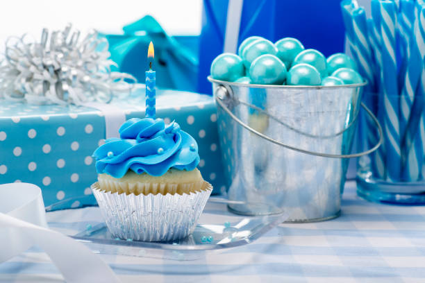 One Year Old Boy Birthday Cupcake with candy and present decorations on a blue background