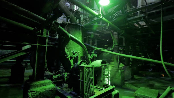 istock Abandoned industrial interior in dark colors with glowing green lights 2203307452