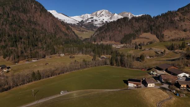 istock Snow-capped mountains under a clear blue sky, 2203311061