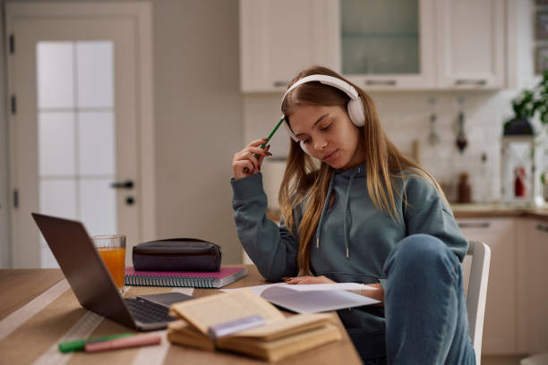 istock Pensive female student learning at home. 2203312532