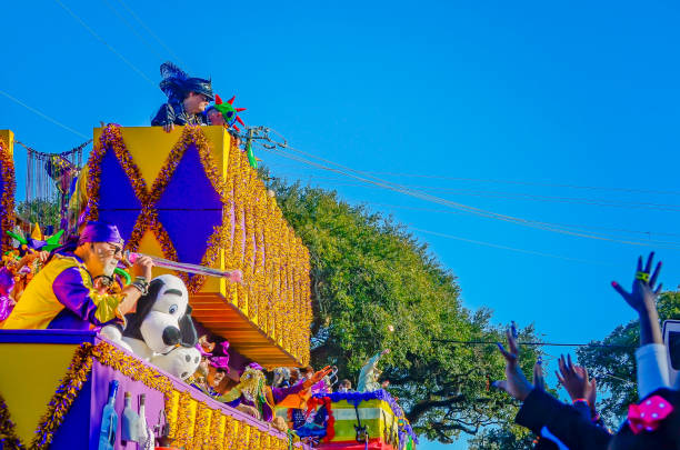Mobile, Alabama, USA - Feb. 7, 2016: A man throws a baton from a Mardi Gras float during the Joe Cain Day Mardi Gras parade in Mobile, Alabama.