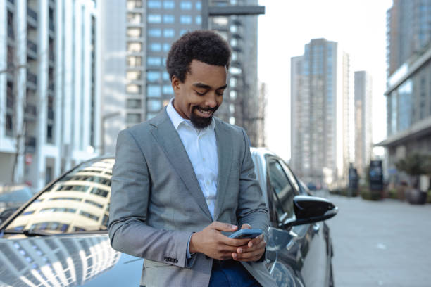 istock Smiling professional man using smartphone in an urban modern cityscape setting 2203320168