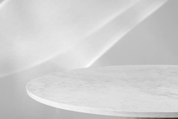 istock Round marble table top with abstract shadow drop on white wall background for mockup product display 2203321840