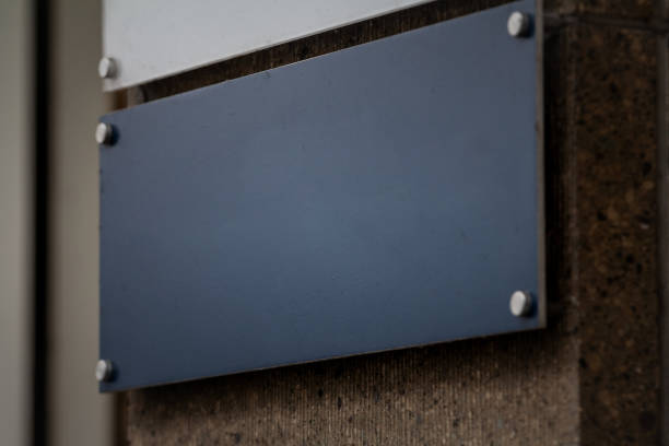 istock A rectangular black sign, serving as a plaque, mounted on an office building wall in Germany. Its sleek appearance provides a professional look, ideal for official or business purposes. 2203327587