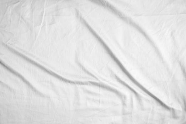 istock Abstract white wrinkled bedding sheet fabric texture background 2203331040