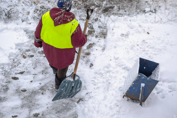 istock A municipal worker with a shovel walks along a cleared path in the park. A public utility worker clearing snow from the road in winter. 2203331628