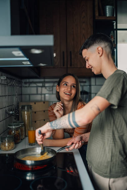 istock Lesbian couple cooking together in modern kitchen 2203331805