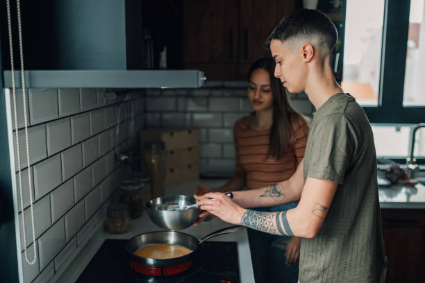 istock Lesbian couple preparing meal together in modern kitchen 2203331825