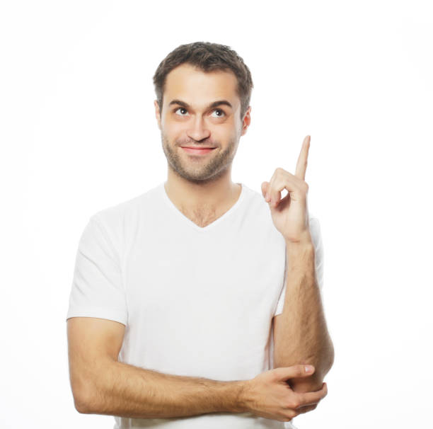 istock Young smiling happy man shows something 2203331853
