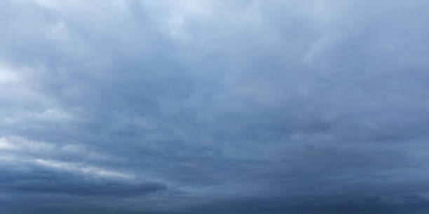 istock Gentle and soft clouds covering dark sky. Background photo texture 2203332527