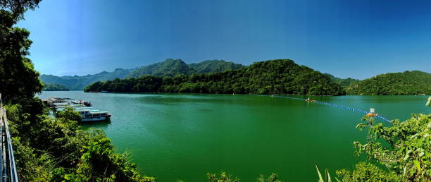 istock Serene Reservoir Surrounded by Verdant Mountains 2203333221