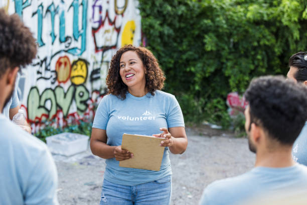 istock Volunteer leader giving a presentation to a diverse group 2203334105