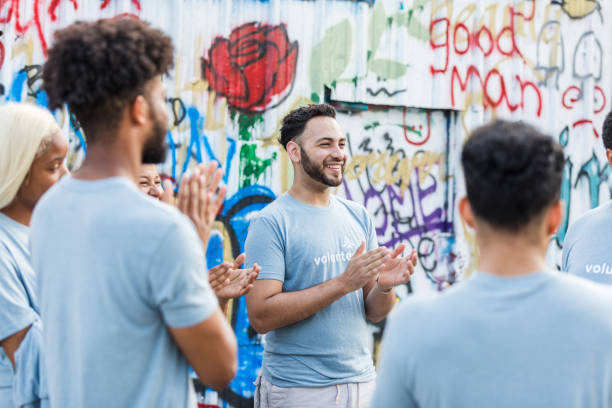 istock Multiracial Group of Volunteers Applauding a Speaker 2203334108