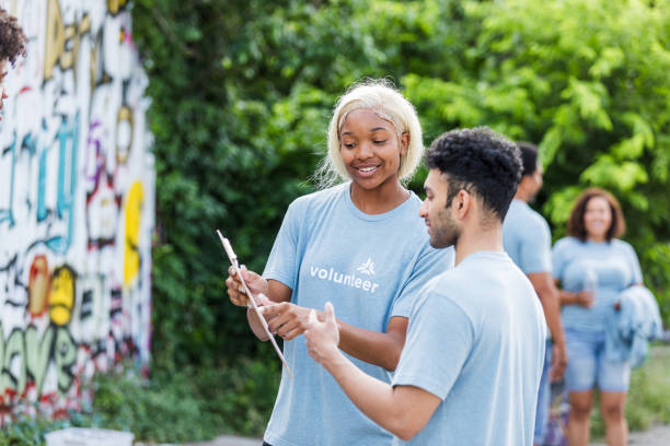 istock Two Volunteers Discussing Project Details on a Clipboard 2203334120