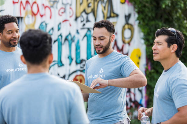 istock Teamwork and Volunteerism: Diverse Group of People Working Together 2203334127
