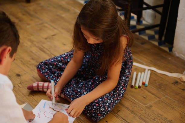 istock Children Drawing Indoors Together 2203334600