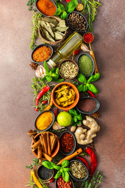 istock An artistic display of fragrant herbs and spices, scattered on a brown surface, blending natural hues and rich textures for a rustic culinary charm 2203335264