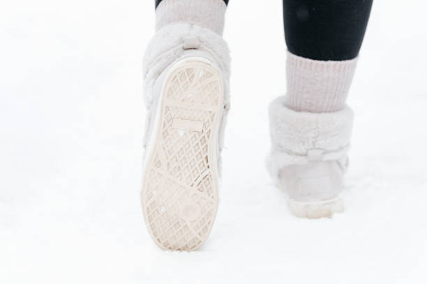 istock young woman walks on white snow 2203335597