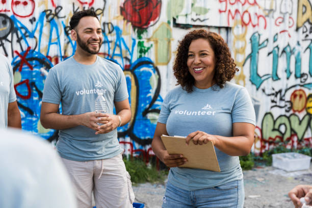 istock Two Volunteers Smiling, Community Outreach Event 2203335820