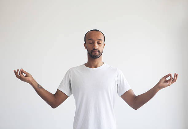 istock Young afro man concentrating his mind, meditating, yoga exercise breath technique reduce stress. 2203336146