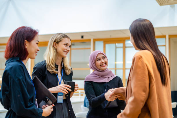 istock diversify business persons shaking hands in office 2203338289