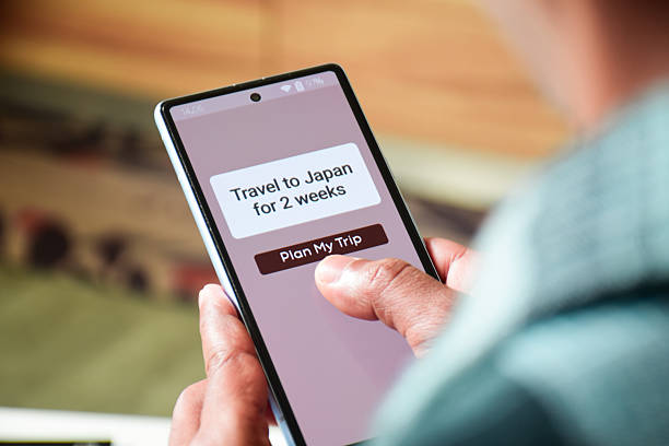istock Man using mobile applications to make travel itineraries for his upcoming trips to Japan. Vacation planning using Artificial intelligence concepts, digital display. 2203339263